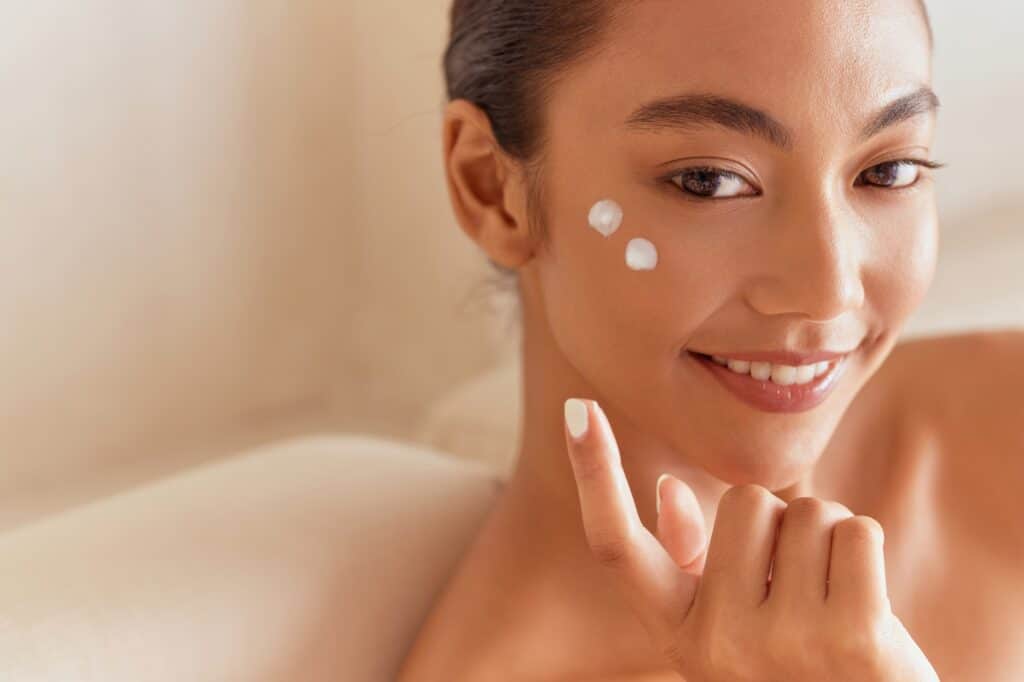 Skincare Beauty. Woman Applying Face Cream in Skincare and Beauty Routine
