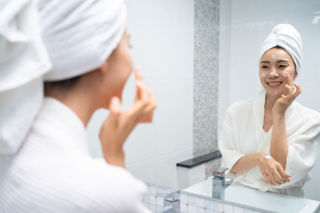 Asian beautiful woman putting smooth and skin care for facial soft.