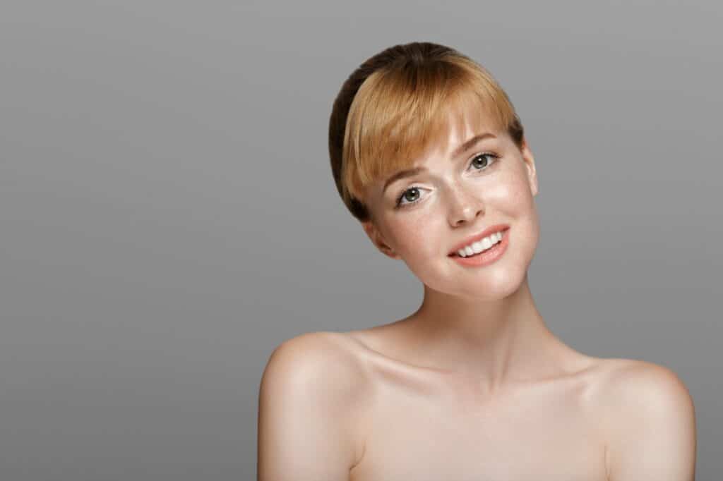 Beauty woman with red hair freckles skin