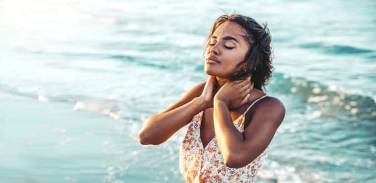 Relaxed african woman enjoying sun and freedom outdoors